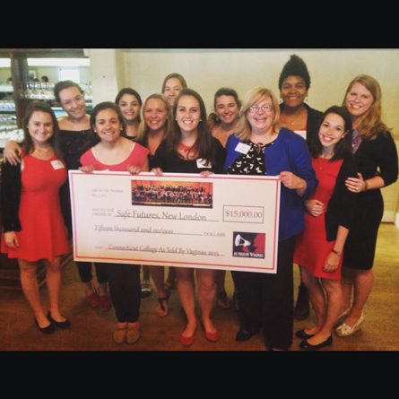 Bettina Weiss '15, center, the As Told By Vaginas leadership team, and Director of Sexual Violence Prevention and Advocacy Darcie Folsom, back right, present a $15,000 check to Cathy Zeiner, executive director of Safe Futures.