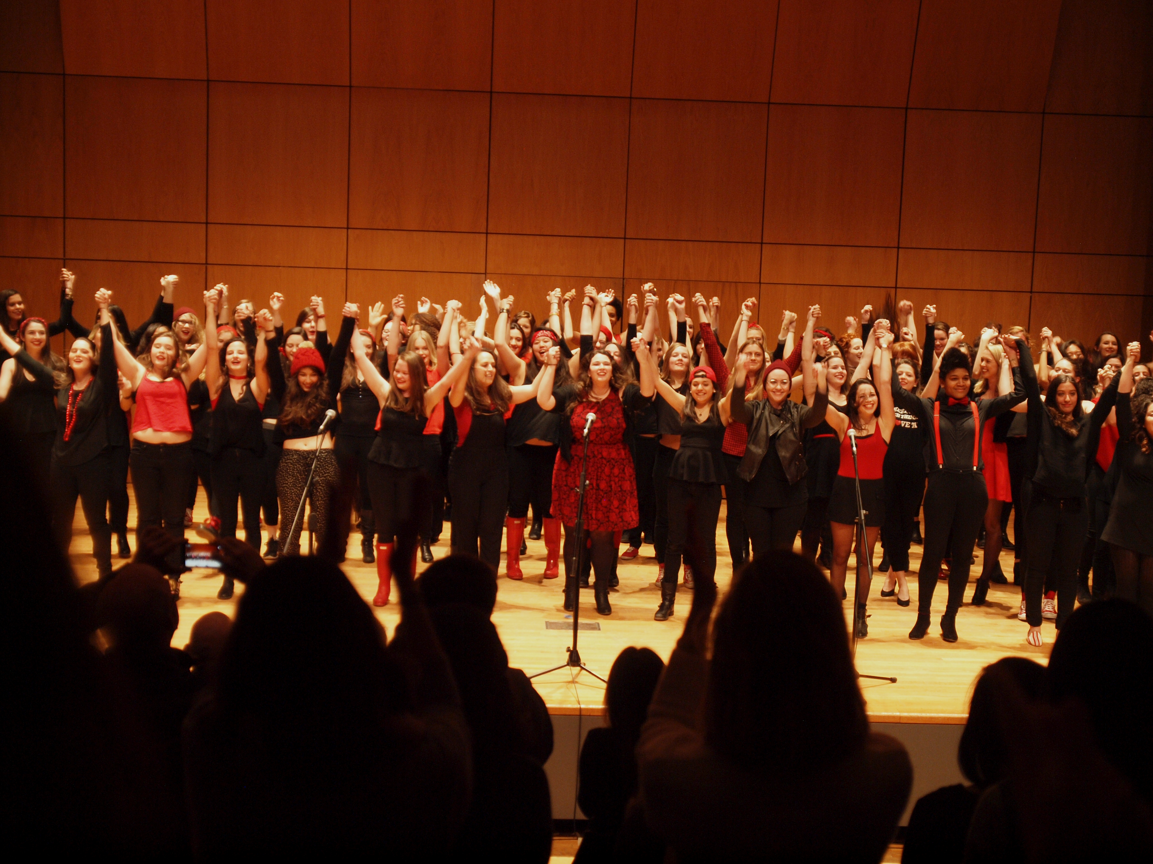 Students take a bow on stage after performing monologues written by their peers about the female experience