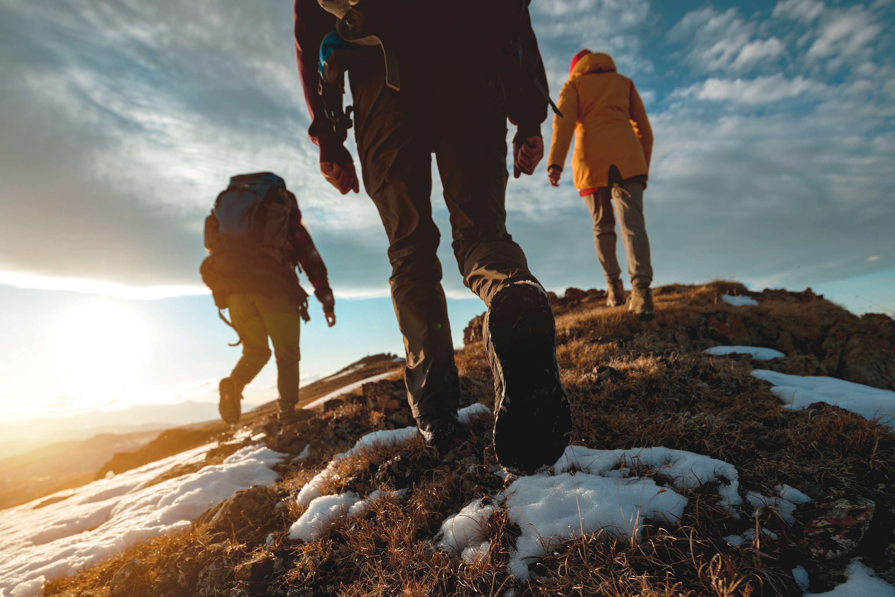 Image of hikers with backpacks from behind