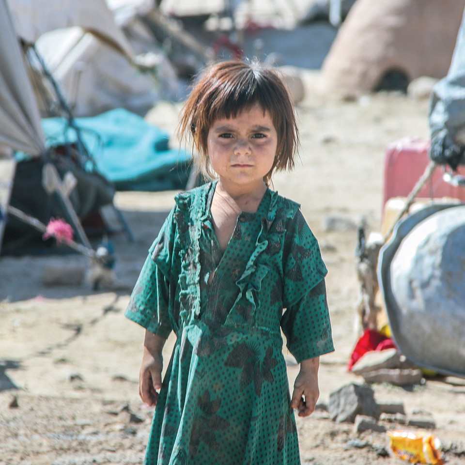 Child on desolate landscape in Afghanistan