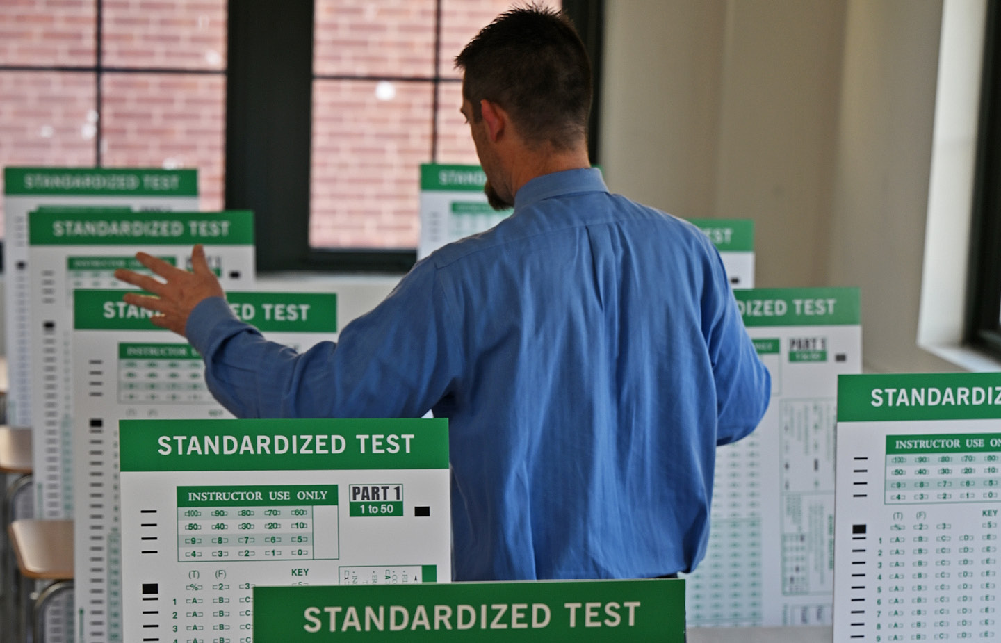 Conceptual image of teacher teaching to a bunch of tests