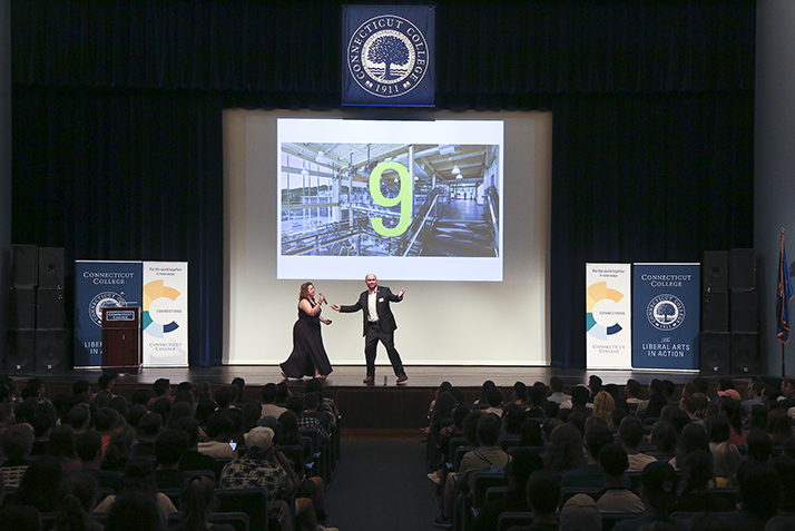 Student life staff talk to an auditorium full of new students