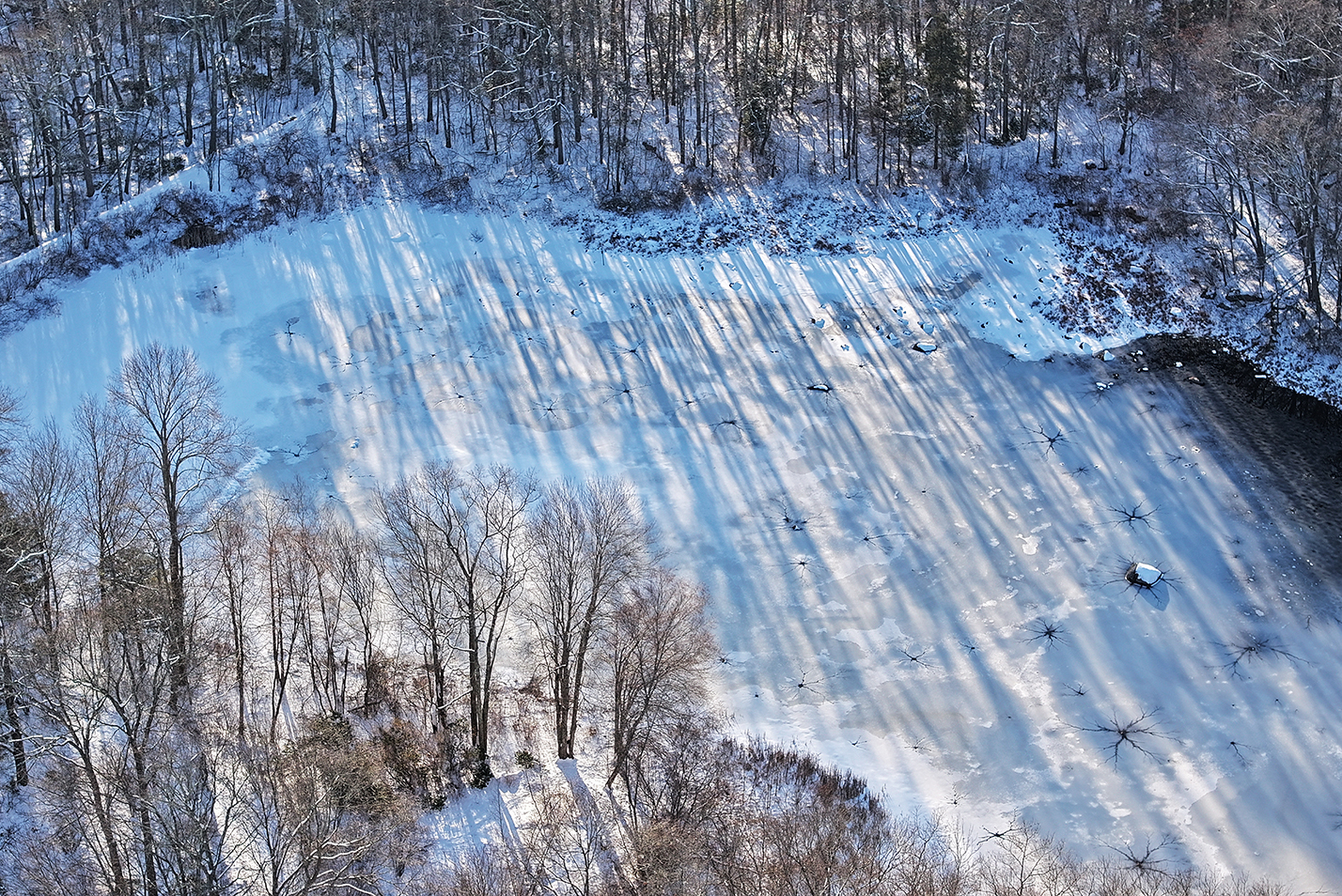 An ice covered pond from the air.