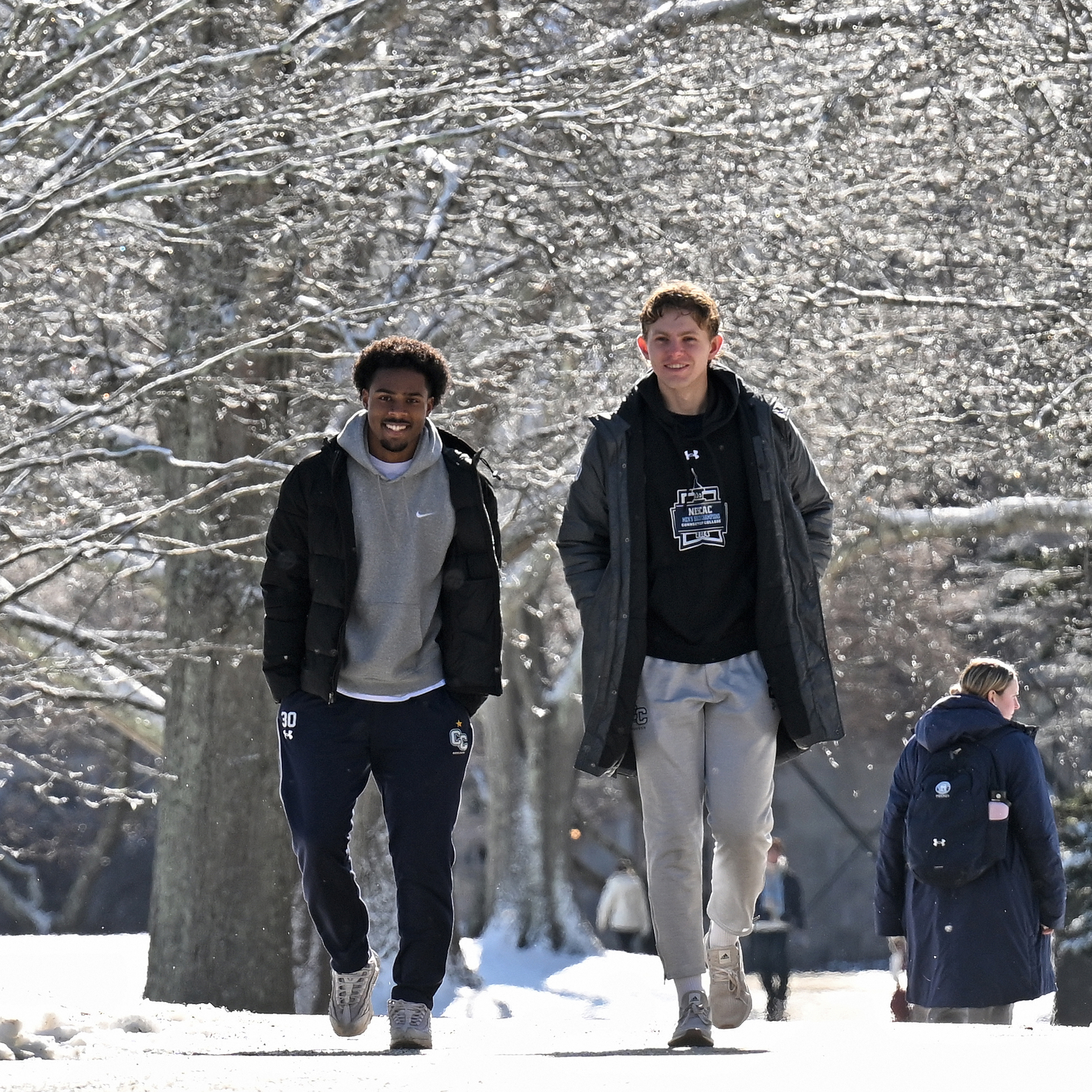 Students walk across a snow-blanketed campus