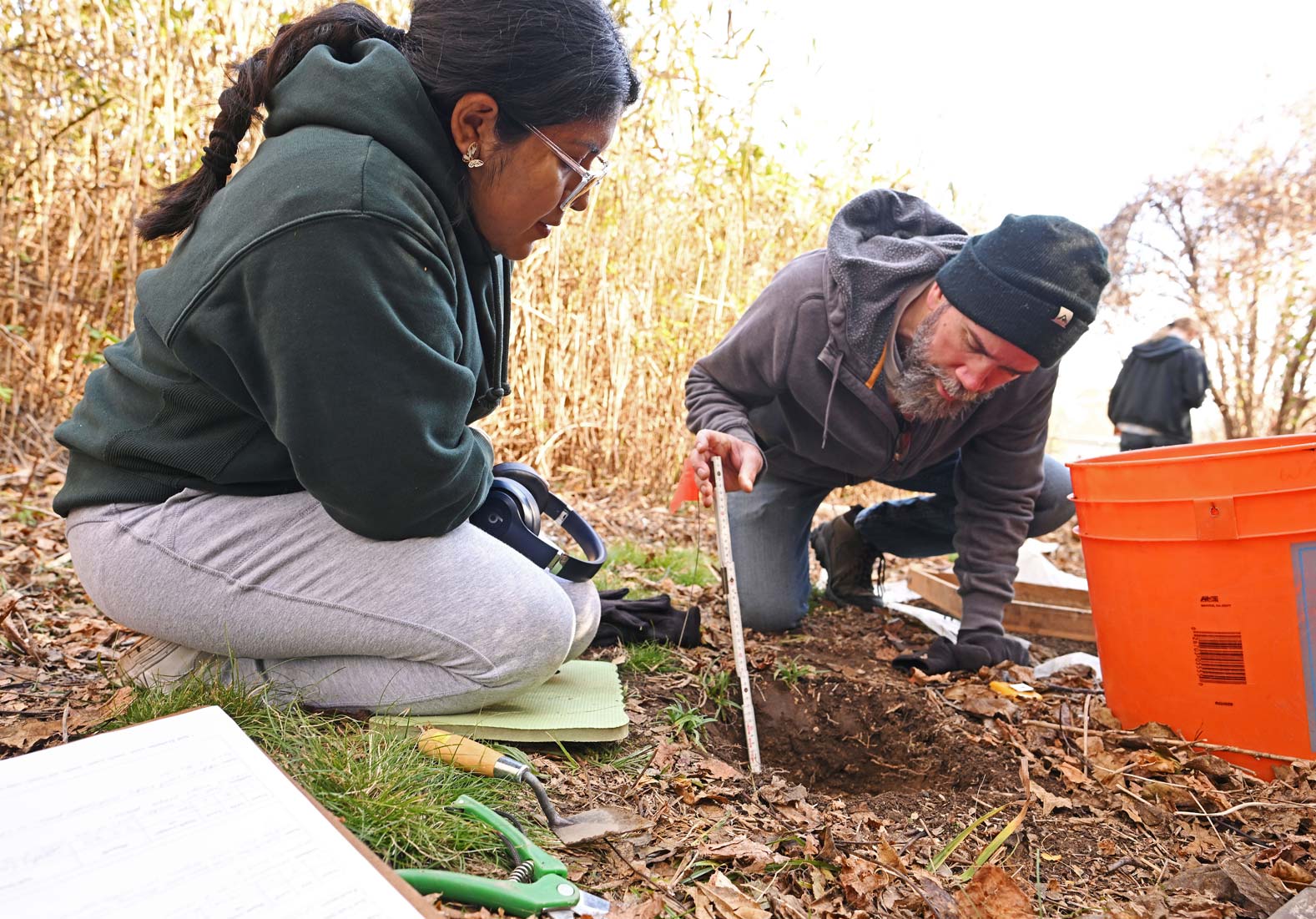 A student and professor working outside